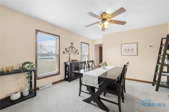 dining area featuring light carpet, baseboards, and visible vents