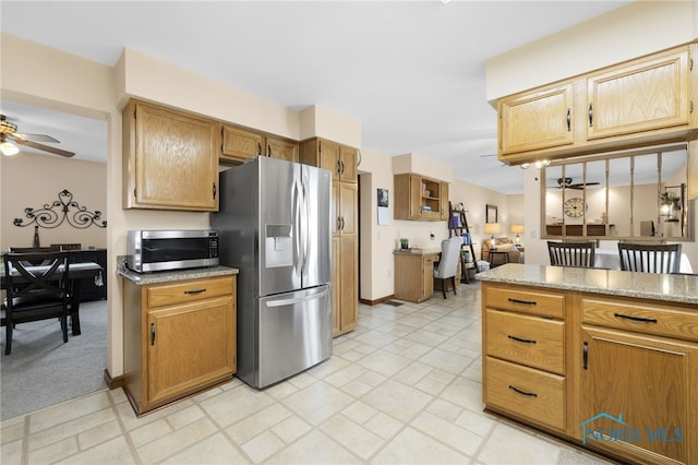 kitchen with stainless steel appliances and a ceiling fan