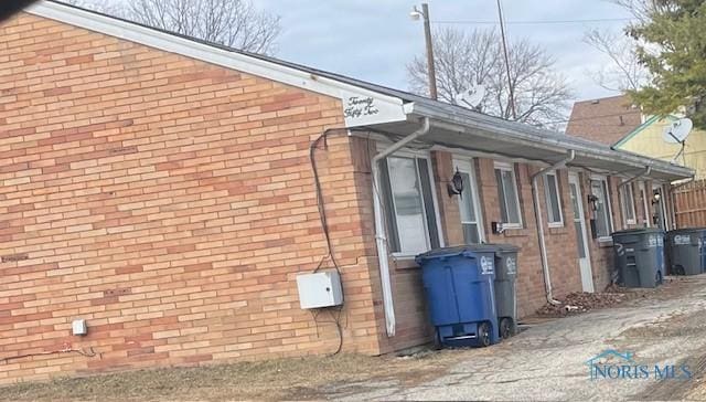 view of side of property featuring brick siding