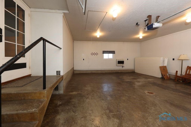 garage featuring heating unit and a garage door opener