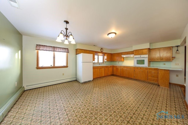 kitchen featuring white appliances, baseboard heating, light countertops, under cabinet range hood, and a sink