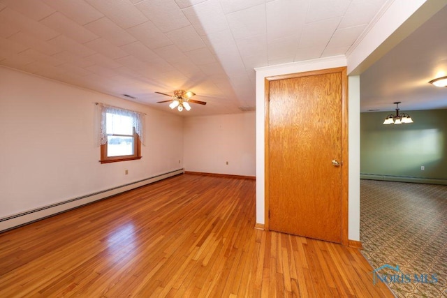 empty room featuring a baseboard radiator, light wood-style flooring, baseboard heating, baseboards, and ceiling fan with notable chandelier