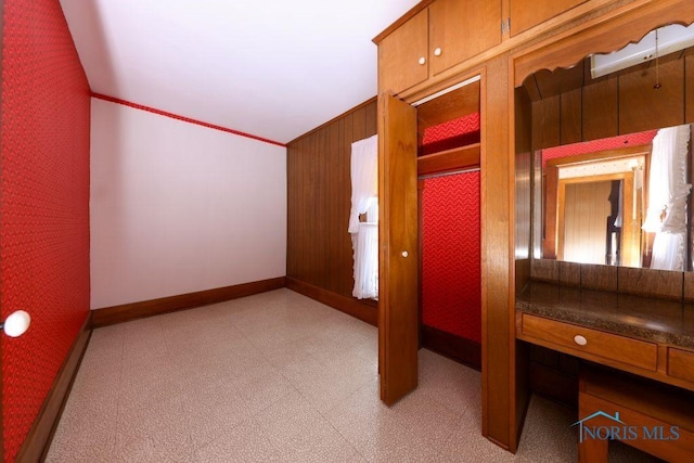 bedroom with light floors, ornamental molding, wallpapered walls, and baseboards