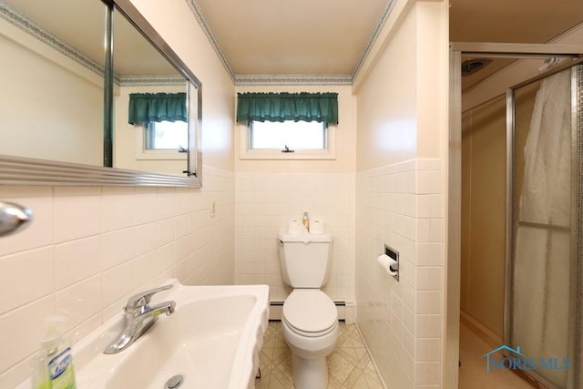 bathroom with tile walls, a baseboard radiator, toilet, a shower stall, and tile patterned flooring