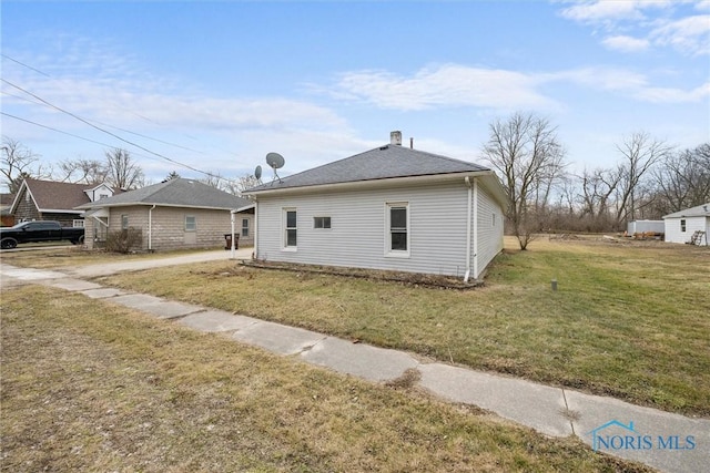 view of side of home featuring a lawn