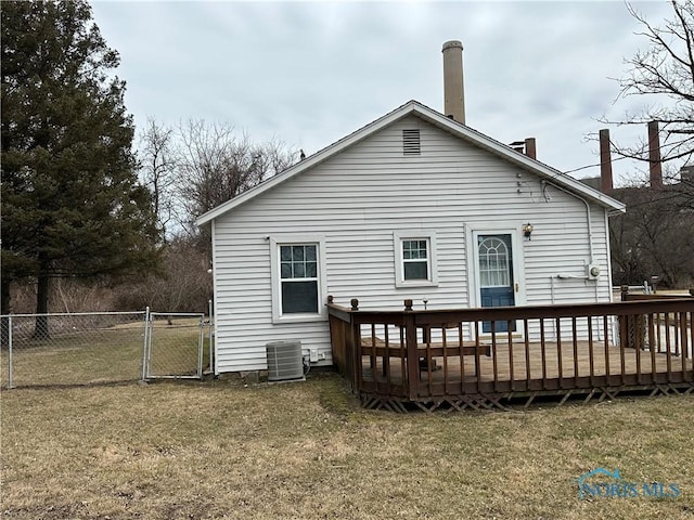 rear view of house with fence, central air condition unit, a wooden deck, a yard, and a gate