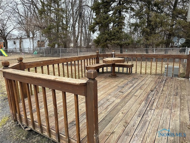 deck featuring a playground and fence