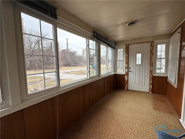 unfurnished sunroom featuring visible vents