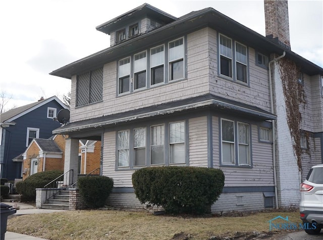 view of front of house featuring crawl space and a chimney