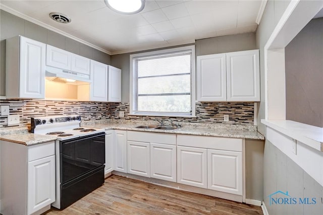 kitchen with range with electric cooktop, under cabinet range hood, ornamental molding, white cabinetry, and a sink