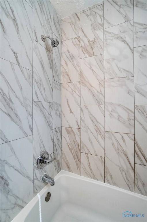 bathroom featuring  shower combination