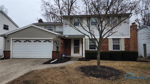 traditional home featuring driveway, brick siding, a chimney, and an attached garage