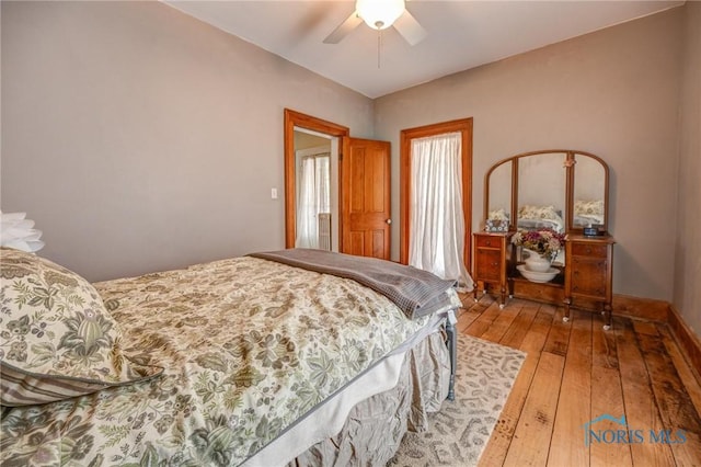 bedroom featuring baseboards, wood-type flooring, and a ceiling fan