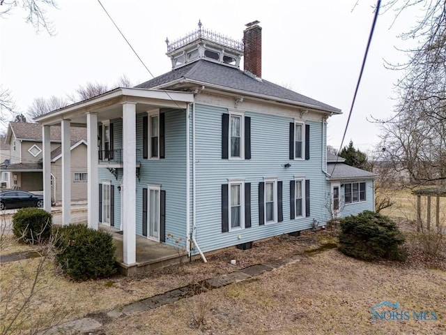 view of side of property featuring a chimney