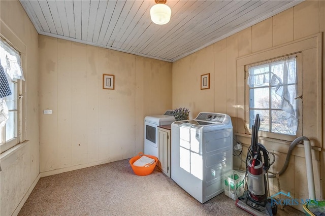 clothes washing area with separate washer and dryer, laundry area, a healthy amount of sunlight, and light colored carpet