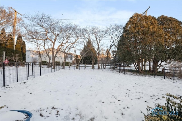 snowy yard with fence