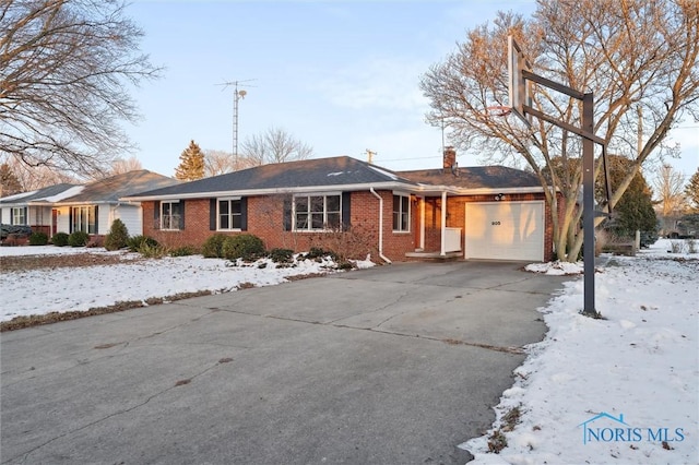 ranch-style house with brick siding, driveway, a chimney, and an attached garage