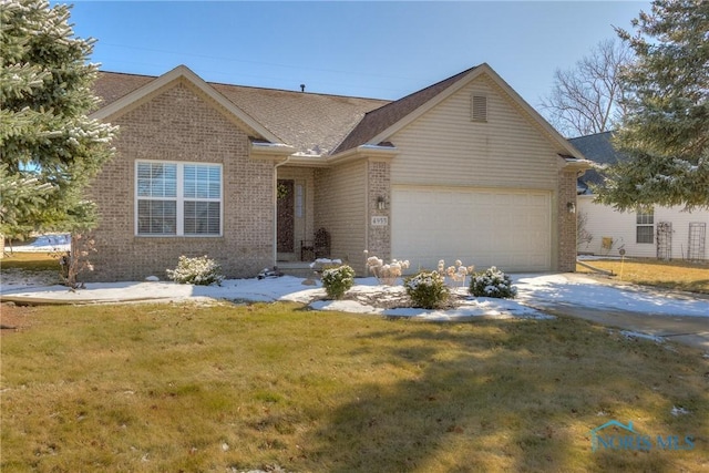 view of front of property with a garage, a front lawn, and brick siding