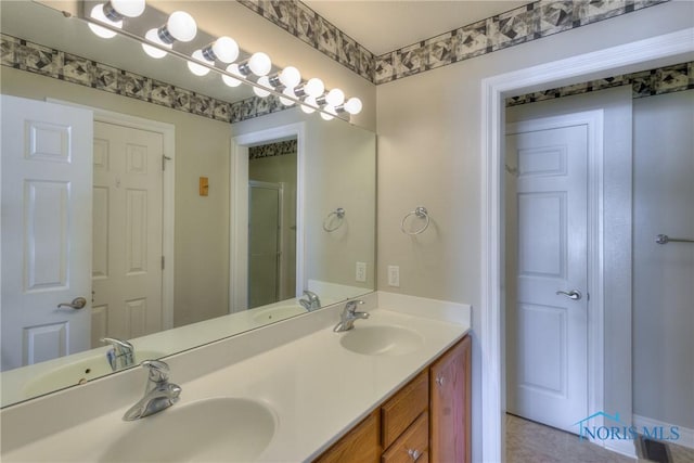 bathroom featuring double vanity and a sink