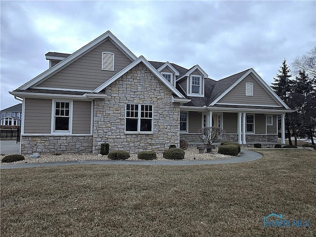 view of front of home featuring covered porch and a front lawn