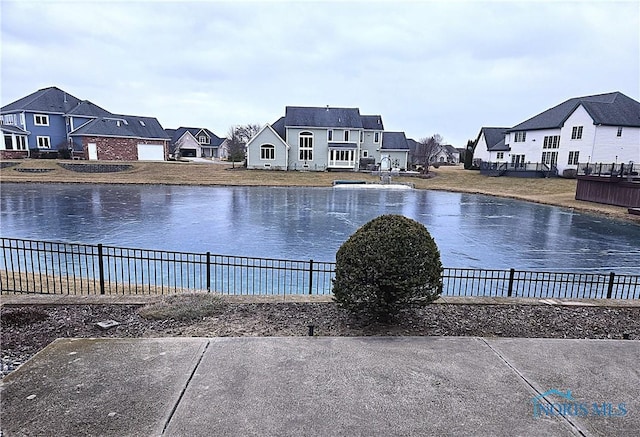 water view with fence and a residential view