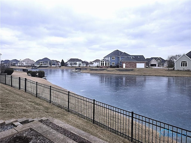 property view of water featuring a residential view and fence