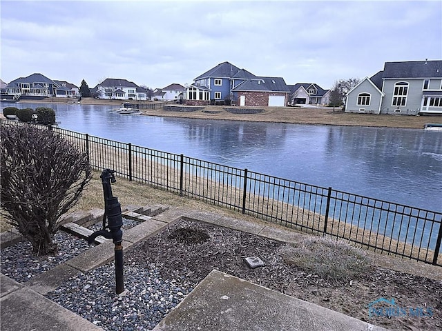 water view with a residential view and a fenced backyard