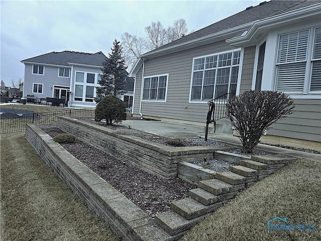 wooden deck with a yard, fence, and a patio