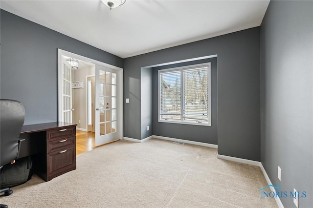 office area featuring light carpet, visible vents, baseboards, and french doors