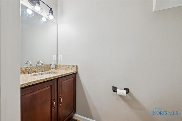 bathroom with vanity and baseboards