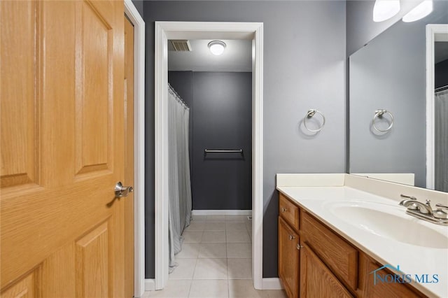 full bath featuring baseboards, visible vents, a shower with shower curtain, tile patterned floors, and vanity