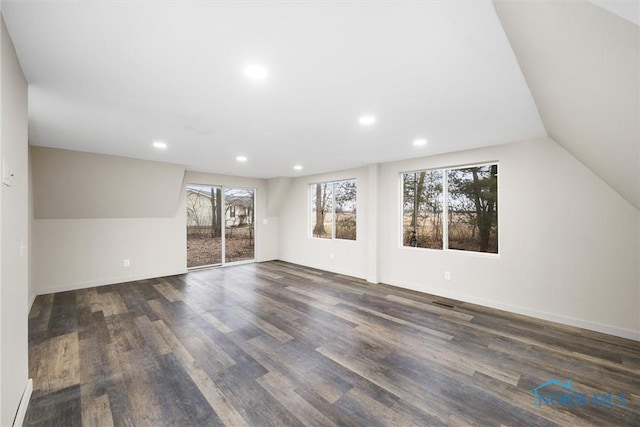 interior space with vaulted ceiling, dark wood-style flooring, recessed lighting, and baseboards