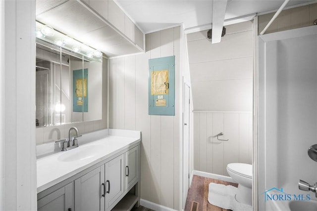 bathroom featuring visible vents, toilet, vanity, wood finished floors, and walk in shower