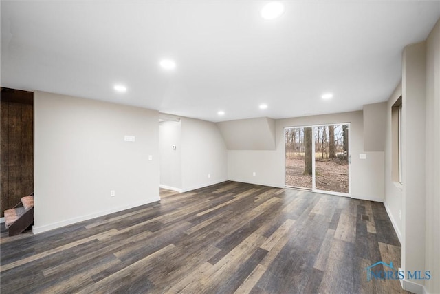 empty room with baseboards, dark wood-type flooring, and recessed lighting