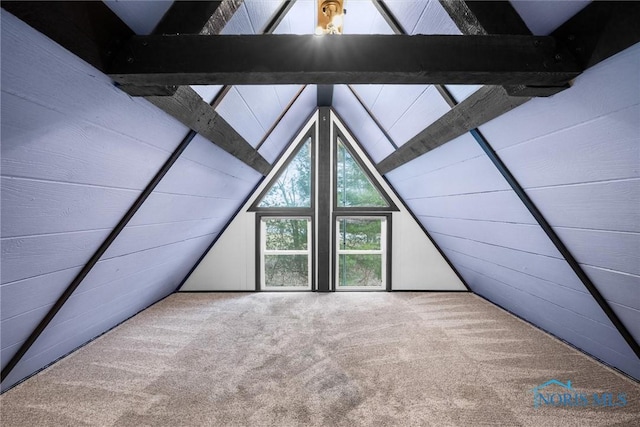 bonus room featuring lofted ceiling with beams and carpet