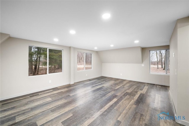 unfurnished room featuring baseboards, visible vents, wood finished floors, and recessed lighting