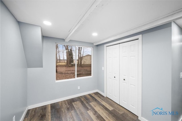 unfurnished bedroom with a closet, baseboards, dark wood-style flooring, and recessed lighting