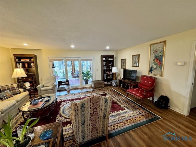 living area featuring wood finished floors, built in features, and recessed lighting