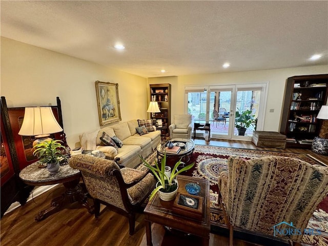 living area with recessed lighting, french doors, a textured ceiling, and wood finished floors