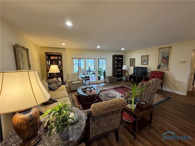 living room with wood finished floors and recessed lighting