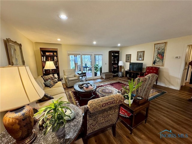 living area with wood finished floors and recessed lighting