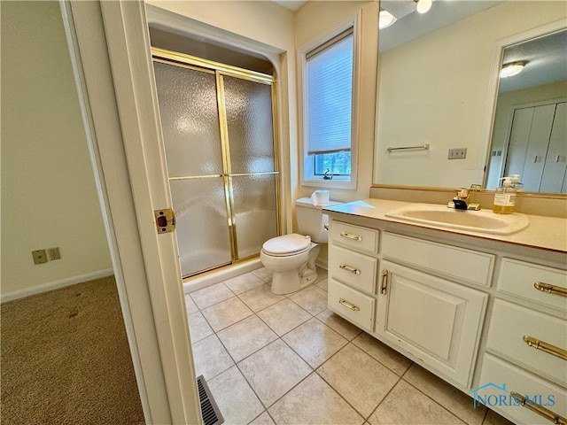 full bathroom featuring toilet, vanity, visible vents, tile patterned floors, and a stall shower