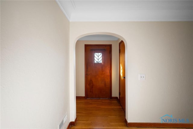 8134 W Central Ave, Toledo, OH 43617 - hall featuring wood finished floors, baseboards, visible vents, arched walkways, and ornamental molding