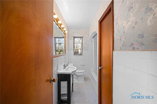 8134 W Central Ave, Toledo, OH 43617 - full bath with wallpapered walls, toilet, wainscoting, tile patterned floors, and vanity
