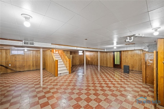 8134 W Central Ave, Toledo, OH 43617 - below grade area featuring stairs, light floors, visible vents, and wood walls