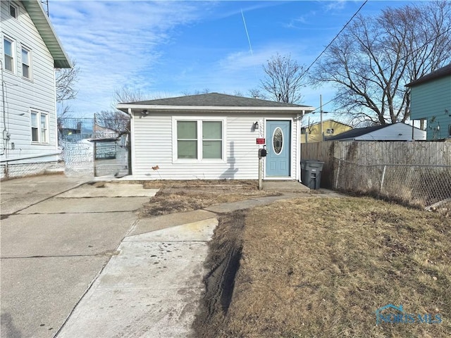 view of front of home featuring fence