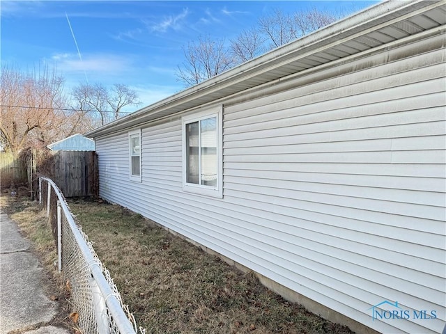 view of side of home with fence