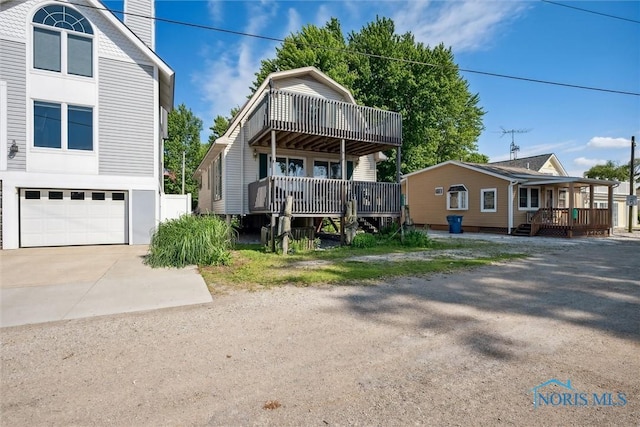 view of front of house featuring a garage, covered porch, and concrete driveway