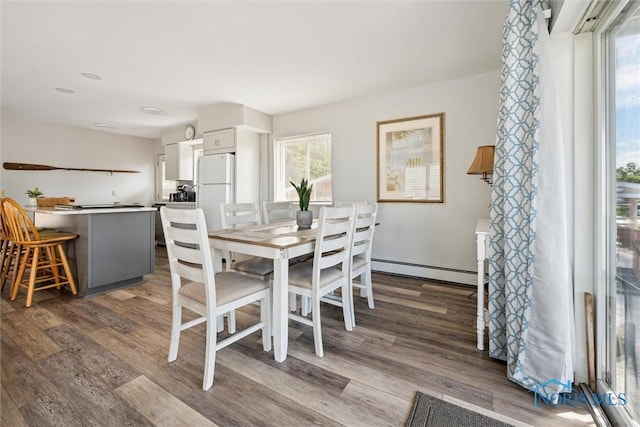 dining room featuring dark wood-style floors and a baseboard radiator