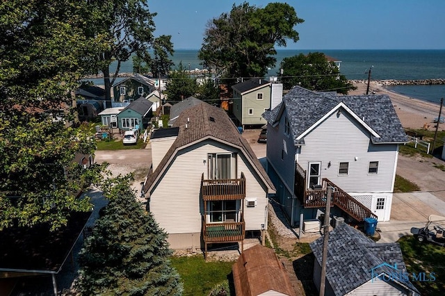 drone / aerial view featuring a water view and a residential view